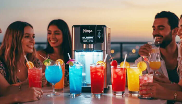 Group of friends enjoying colorful frozen drinks made with a Ninja Slushie machine at a party.