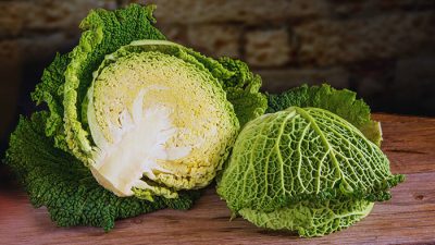 Freshly cut cabbage showing the texture, associated with potential negative effects of cabbage on ladies, such as bloating and digestive discomfort.