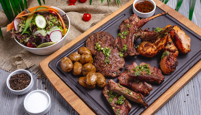 Selection of grilled beef cuts, salmon, and vegetables displayed for inspiration in a 30-Day Carnivore Diet Meal Plan.