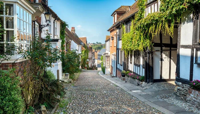 Charming cobbled street with historic timbered houses in Rye, showcasing one of the top Things To Do In Rye, East Sussex.