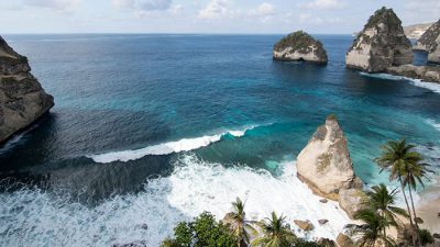 Stunning aerial view of turquoise waters and limestone cliffs at Atuh Beach Nusa Penida, one of Bali’s most beautiful hidden beaches.