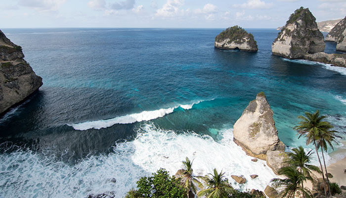 Stunning aerial view of turquoise waters and limestone cliffs at Atuh Beach Nusa Penida, one of Bali’s most beautiful hidden beaches.