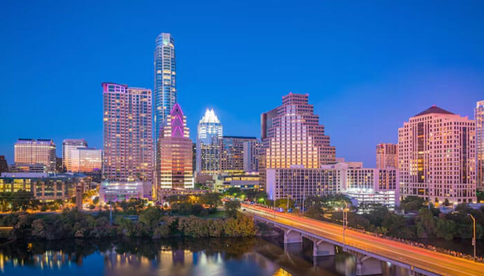Downtown Austin skyline illuminated at dusk with river reflections — among the best places to visit in USA for culture, music, and nightlife.