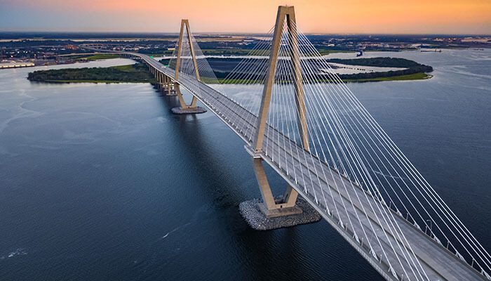 Aerial view of Arthur Ravenel Jr. Bridge stretching over the Cooper River during sunset