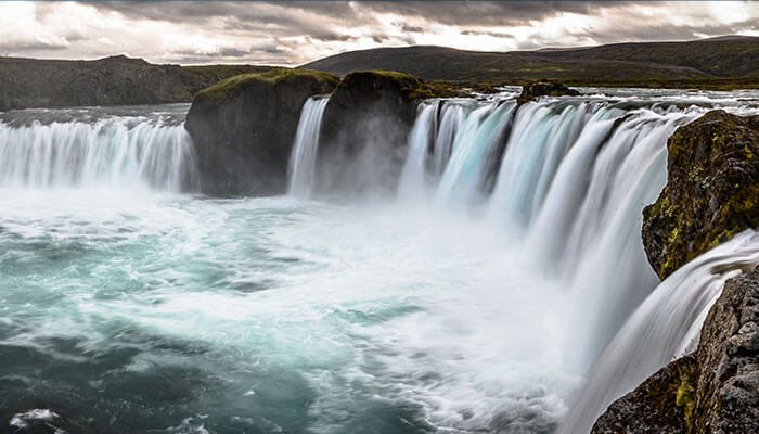 Powerful flow of Niagara Falls cascading over rocks with mist rising — one of Canada’s most iconic natural attractions.
