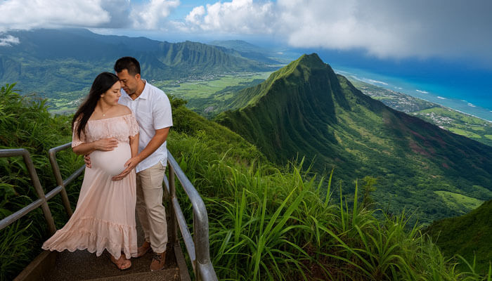 Couple embracing during their babymoon adventure at a breathtaking mountain viewpoint, showcasing one of the most beautiful babymoon destinations.