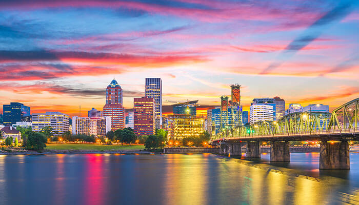 Downtown Portland skyline reflecting on the Willamette River at twilight
