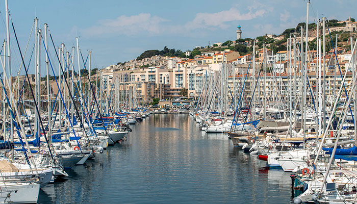 Rows of sailboats docked in a serene port in Cassis, reflecting the calm beauty of a south of France vacation.
