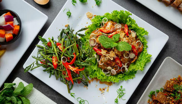Colorful Thai salad served with herbs, lettuce, and chili — one of the best Thai dishes known for its vibrant flavors and fresh ingredients.