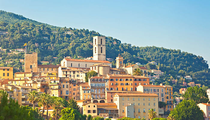 The charming old town of Grasse with hillside houses and a historic church, a peaceful stop during a south of France vacation.