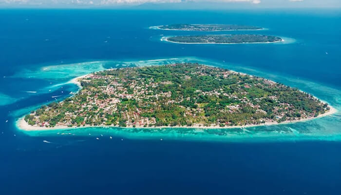 A stunning aerial view of Gili Trawangan, one of the Gili Islands in Indonesia, with pristine beaches and crystal-clear water surrounding the island.