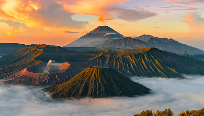 A captivating view of Mount Bromo at sunrise, with volcanic peaks surrounded by mist and the vibrant colors of the early morning sky.