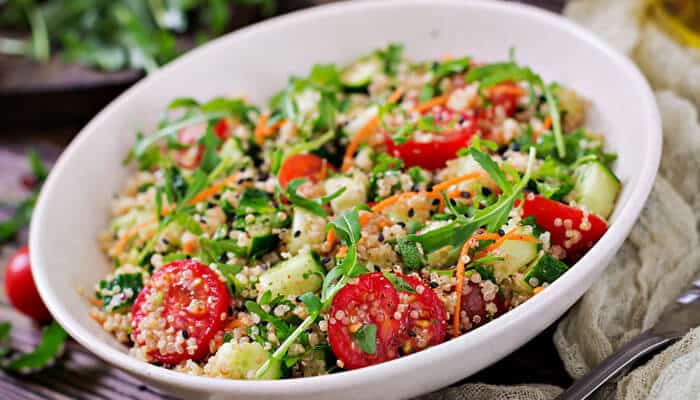 Greek chickpea salad - Food Fun Trip - FoodFunTrip A quinoa salad with tomatoes, cucumber, and arugula, offering a nutrient-rich option for a healthy and delicious meal