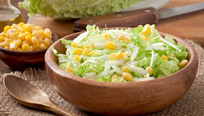 Healthy green salad recipe to try - Food Fun Trip - FoodFunTrip A fresh corn and lettuce salad in a wooden bowl, a healthy and simple dish perfect for light meals