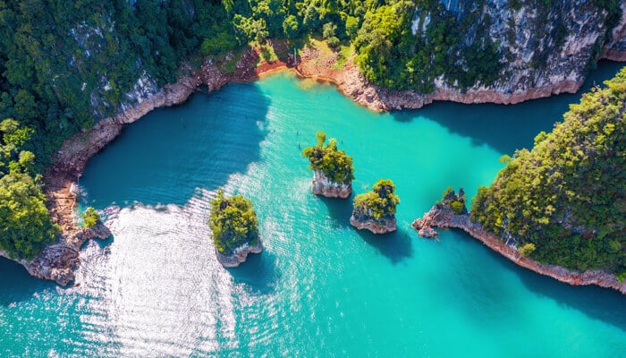 How to Get to James Bond Island Thailand - Food Fun Trip - FoodFunTrip Aerial view of James Bond Island Thailand, with crystal-clear waters and limestone rock formations scattered across the bay