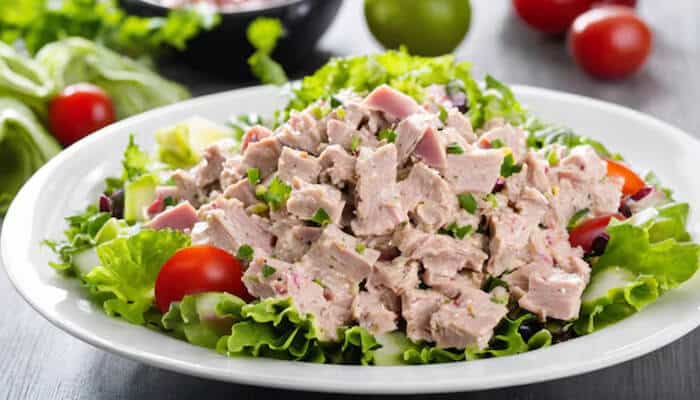 The Best Tuna Salad Recipe - Food Fun Trip - FoodFunTrip A fresh tuna salad made with lettuce, tomatoes, and chopped tuna, offering a protein-packed and healthy meal option