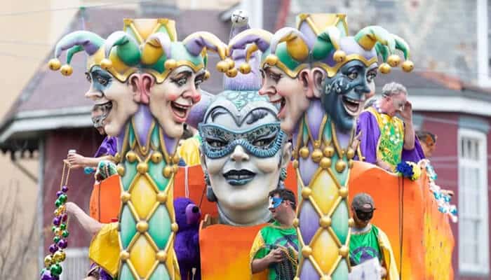 Attend a Festival or Parade - Food Fun Trip - FoodFunTrip A festive Mardi Gras parade float featuring colorful characters and masks, a highlight of New Orleans' iconic celebrations