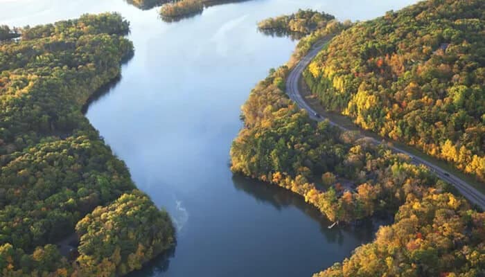 Cruise the Mississippi River - Food Fun Trip - FoodFunTrip A stunning aerial view of a river surrounded by colorful trees, capturing the natural beauty of New Orleans and its surroundings