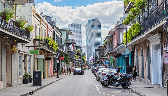 Walk Through Royal Street - Food Fun Trip - FoodFunTrip A picturesque royal street in the French Quarter of New Orleans, lined with vibrant buildings and offering a glimpse of the city’s unique charm