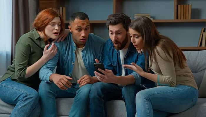 Scary Phone Numbers-Foodfuntrip - FoodFunTrip Scary numbers to call: Four people sitting on a couch, looking shocked and intrigued while looking at a smartphone screen.