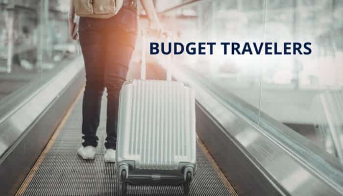 Budget Travelers - Food Fun Trip - FoodFunTrip Travel Tweaks Offers image showing a budget traveler with rolling luggage at an airport, representing smart travel hacks, affordable flight bookings, budget accommodations, fare alerts, and cost-saving strategies for travelers in 2026.