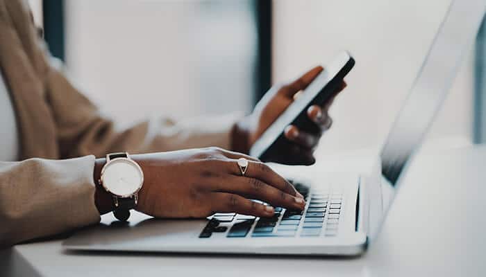 Compare Multiple Booking Platforms - Food Fun Trip - FoodFunTrip Professional traveler using a smartphone and laptop to Book a Flight online, comparing airfare prices, checking airline schedules, and researching budget travel deals for smarter trip planning in 2026.