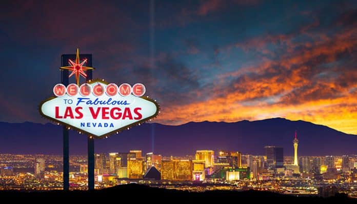 Iconic Welcome to Las Vegas sign at sunset with the vibrant Vegas Strip skyline, showcasing lights, casinos, and mountains — perfect visual for planning your Las Vegas Trip.
