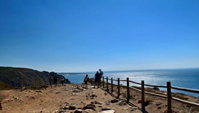 Hikers on a scenic coastal trail in Portugal