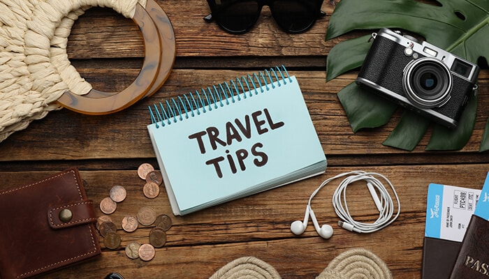 Top Family Travel Tips from My Little Babog - Food Fun Trip - FoodFunTrip Flat lay travel planning setup with notebook labeled “Travel Tips,” passport, camera, headphones, and essentials, representing practical insights from the My Little Babog family lifestyle travel blog for smart trip preparation.