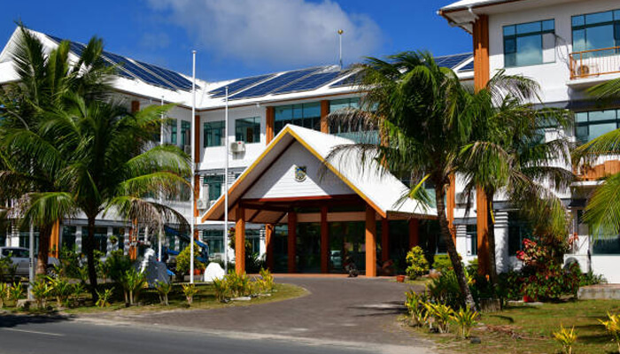 Where to Stay on Yukevalo Island - Food Fun Trip - FoodFunTrip Resort hotel entrance with a peaked wooden portico, tropical landscaping, and solar panels on the roof against a blue sky.