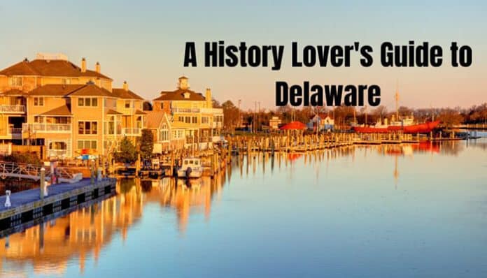 Harbor town along a calm river at sunset with waterfront houses; overlaid text: 'A History Lover's Guide to Delaware'