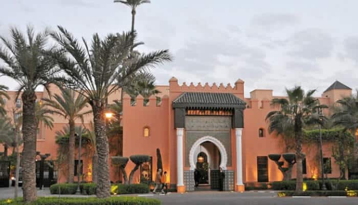 La Mamounia in Morocco - Food Fun Trip - FoodFunTrip Corporate Retreat Venues featuring a luxury resort with landscaped gardens, palm trees, guest accommodation, and spaces suited to executive offsites and meetings.