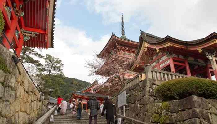 Mount Takao Best for an Easy Nature Escape - Food Fun Trip - FoodFunTrip Tokyo Day Trips featuring a historic Japanese temple with traditional red architecture, stone pathways, cultural landmarks, and peaceful mountain surroundings for a spiritual escape beyond the city