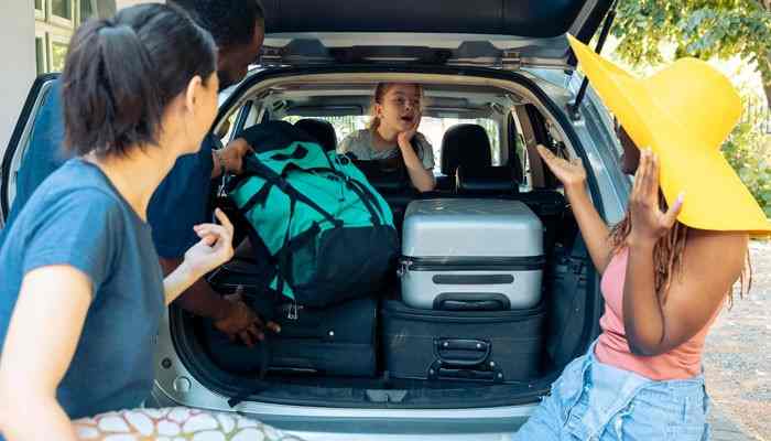 Smart Packing Tips for Road Trips - Food Fun Trip - FoodFunTrip Car Travel With PaxTravelTweaks smart packing scene showing travelers organizing suitcases and travel bags in an SUV cargo area for a safer, comfortable, and well-prepared road trip.