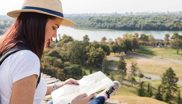 Travel More Responsibly - Food Fun Trip - FoodFunTrip Easy Traveling CwBiancaVoyage traveler exploring nature with a map while practicing responsible travel planning, sustainable tourism habits, destination awareness, and eco-friendly journey preparation for meaningful adventures.
