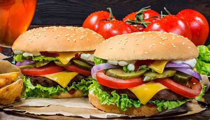 Texas Roadhouse Burgers and Sandwiches Menu - Food Fun Trip - FoodFunTrip Texas Roadhouse Menu With Prices featuring two juicy cheeseburgers topped with melted cheddar cheese, fresh lettuce, tomatoes, pickles, and onions, served with crispy fries.